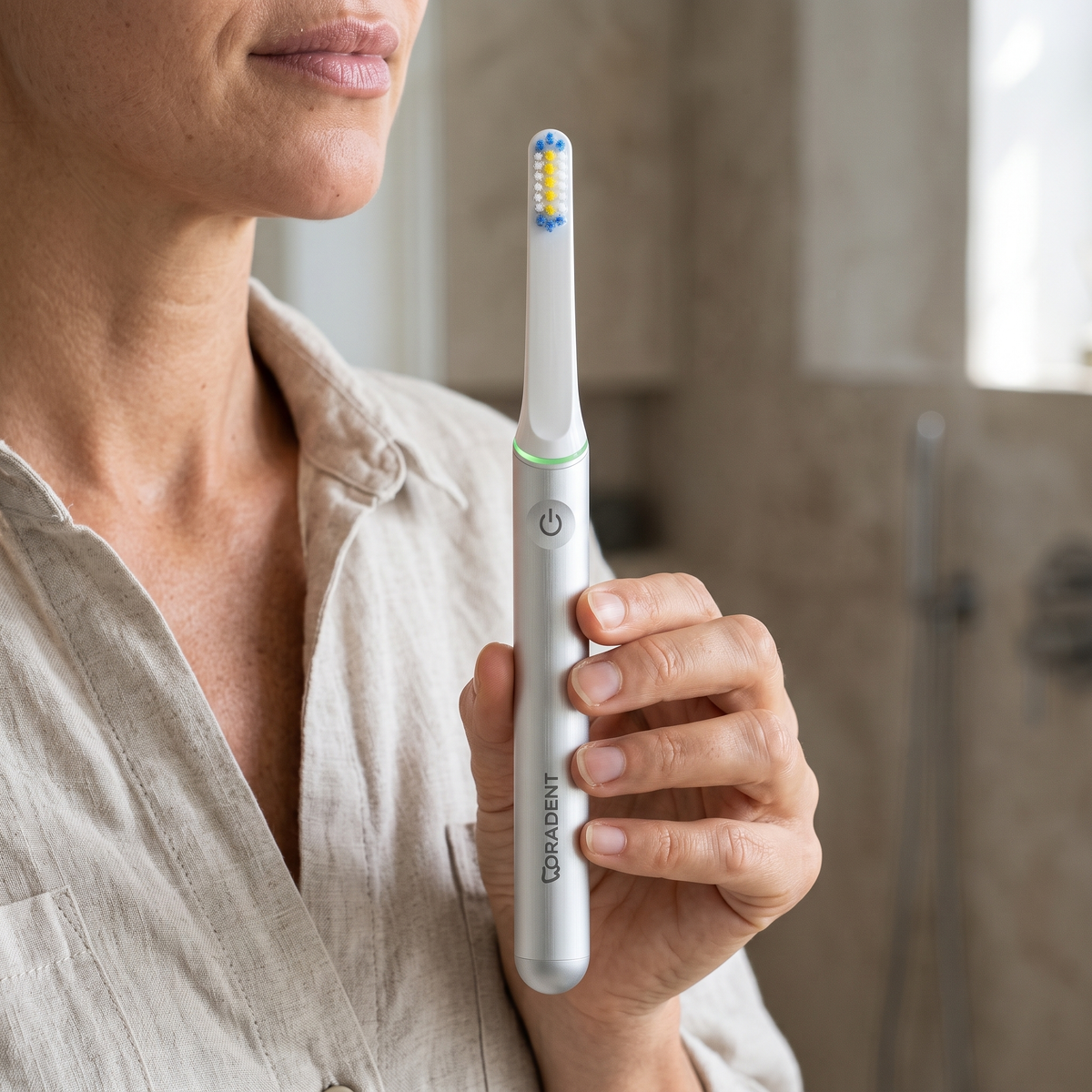 PulseONE sonic toothbrush in Platinum, held in hand