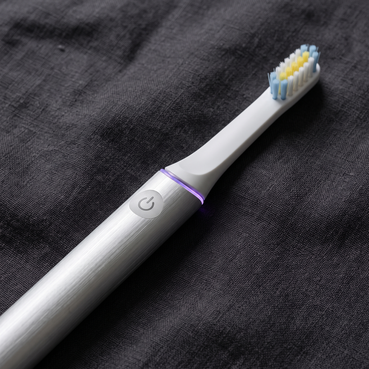 PulseONE sonic toothbrush in Platinum, brushed aluminium body and power button