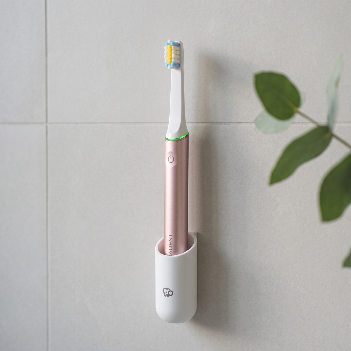 PulseONE sonic toothbrush in Rose, in the WallMount on a bathroom wall