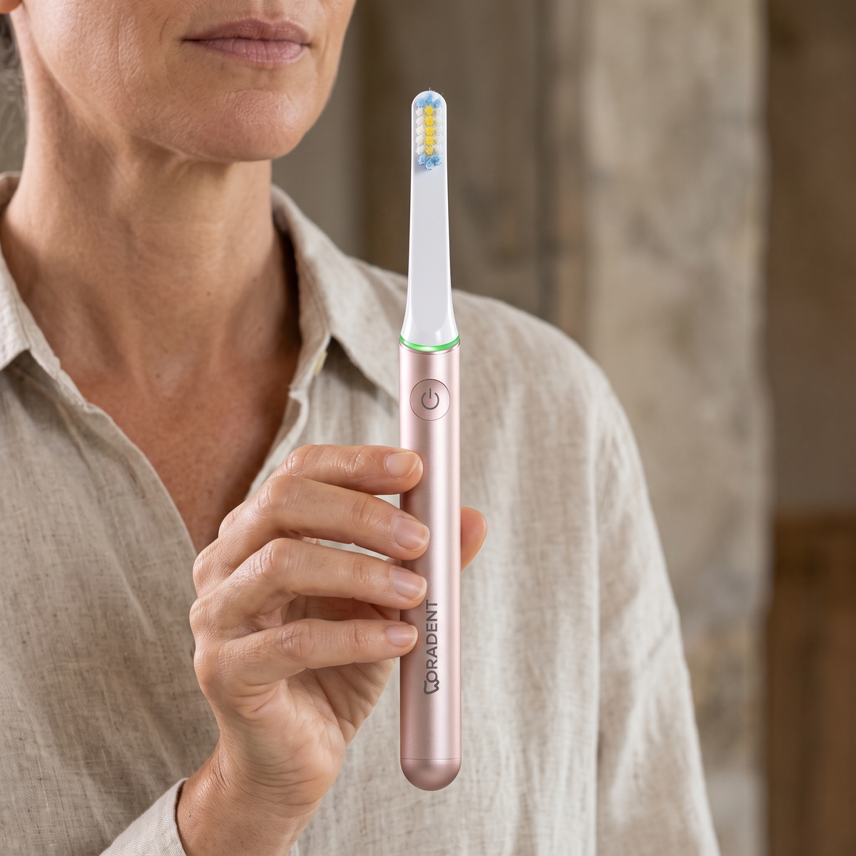 PulseONE sonic toothbrush in Rose, held in hand