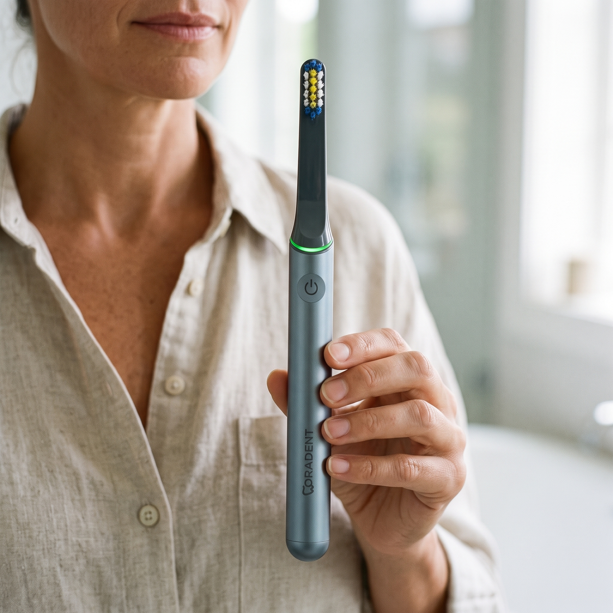 PulseONE sonic toothbrush in Graphite, held in hand