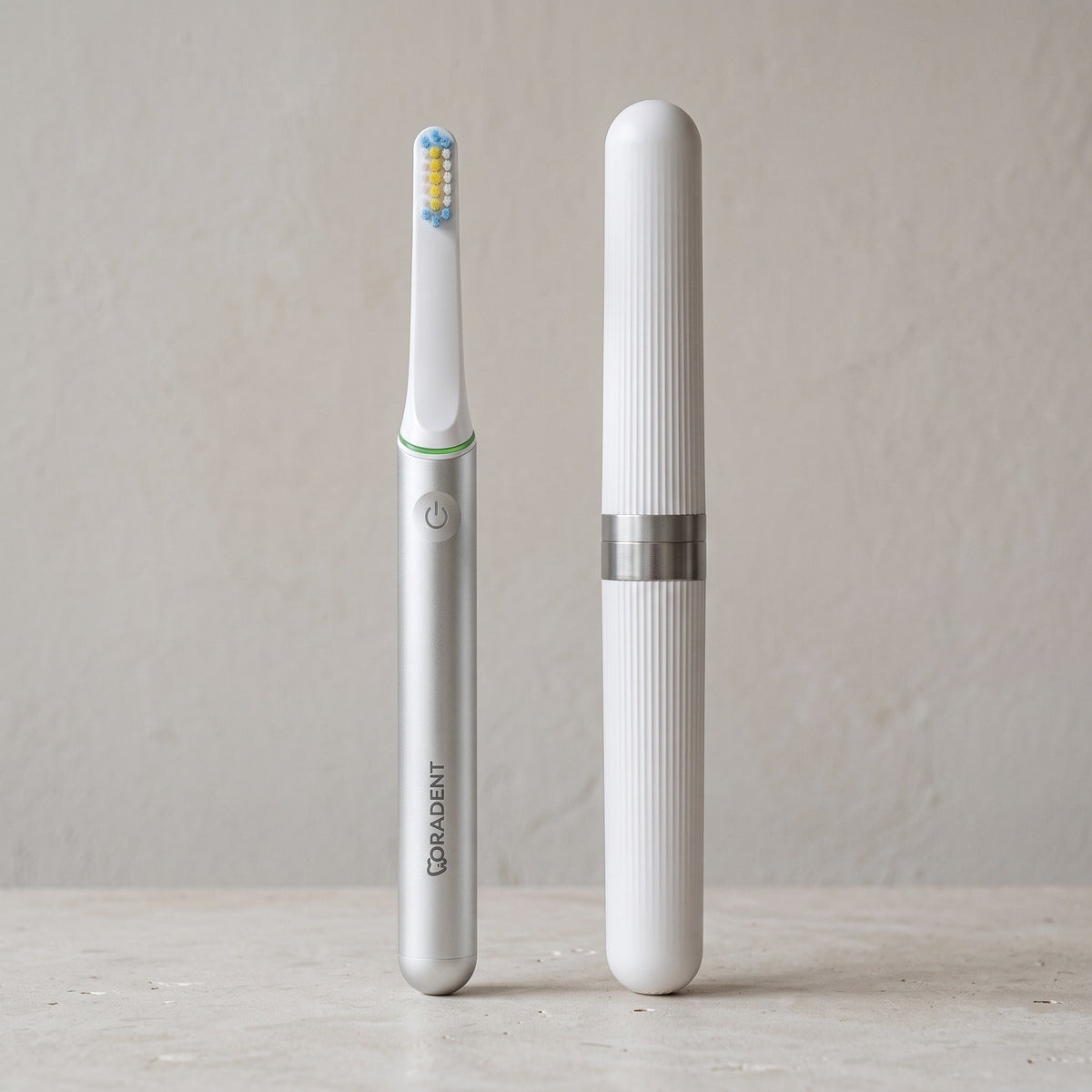 PulseONE sonic toothbrush in Platinum, beside its travel case